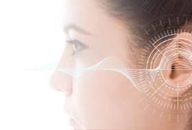 Hearing test showing ear of young woman with sound waves simulation technology - isolated on white banner